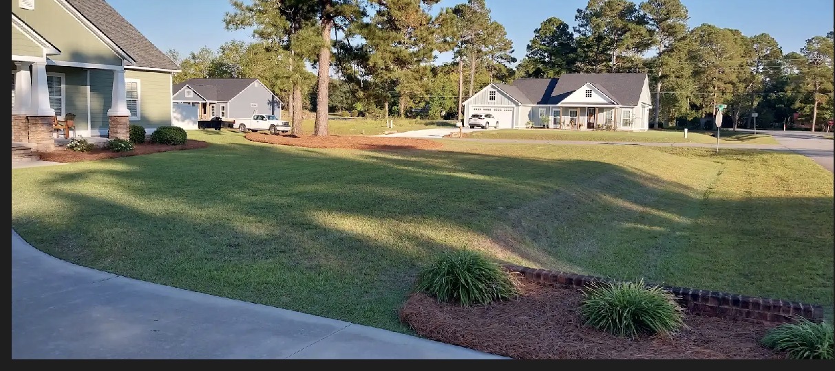 Freshly mowed residential lawn with fresh pine straw beds