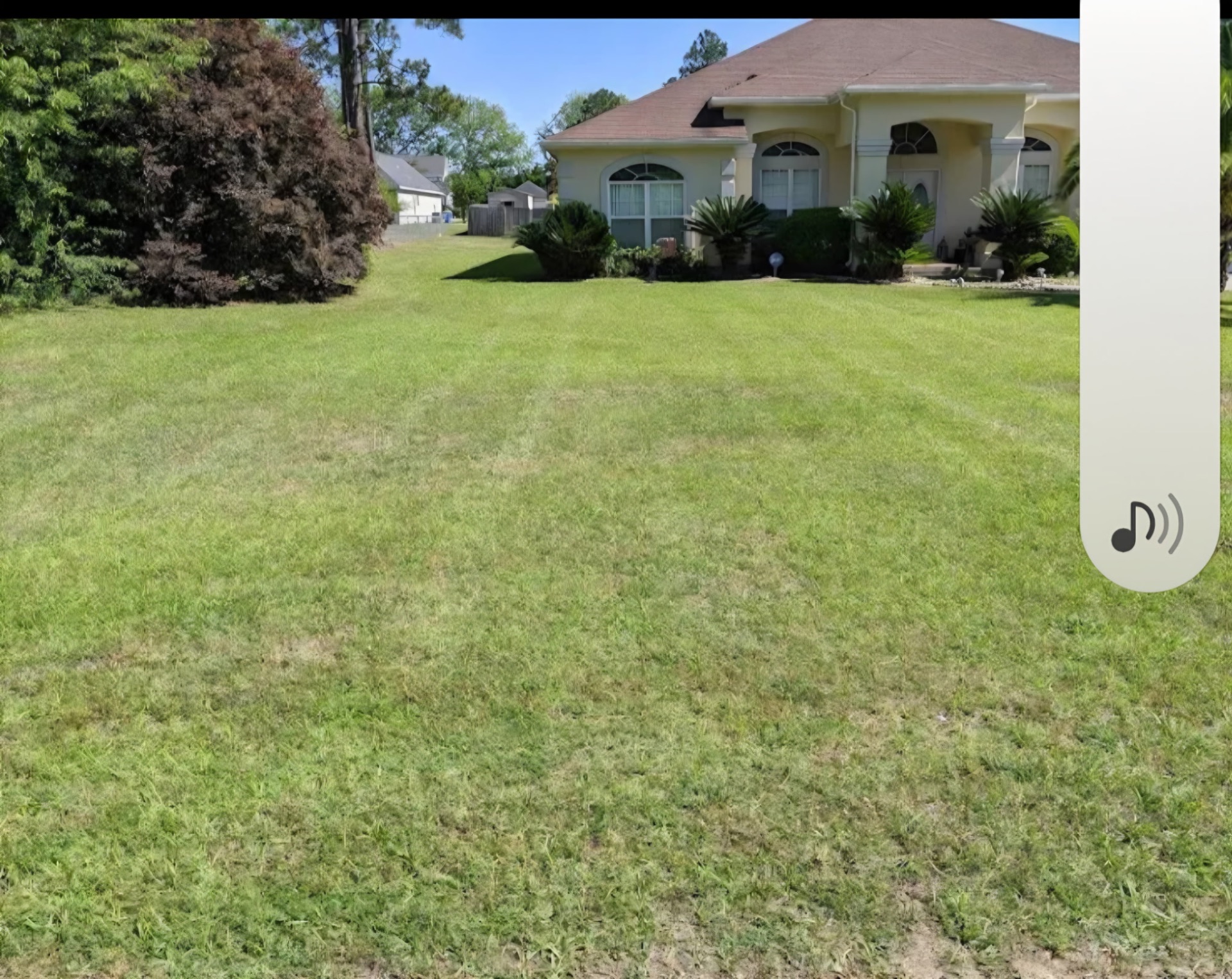Freshly mowed front lawn at large stucco residence