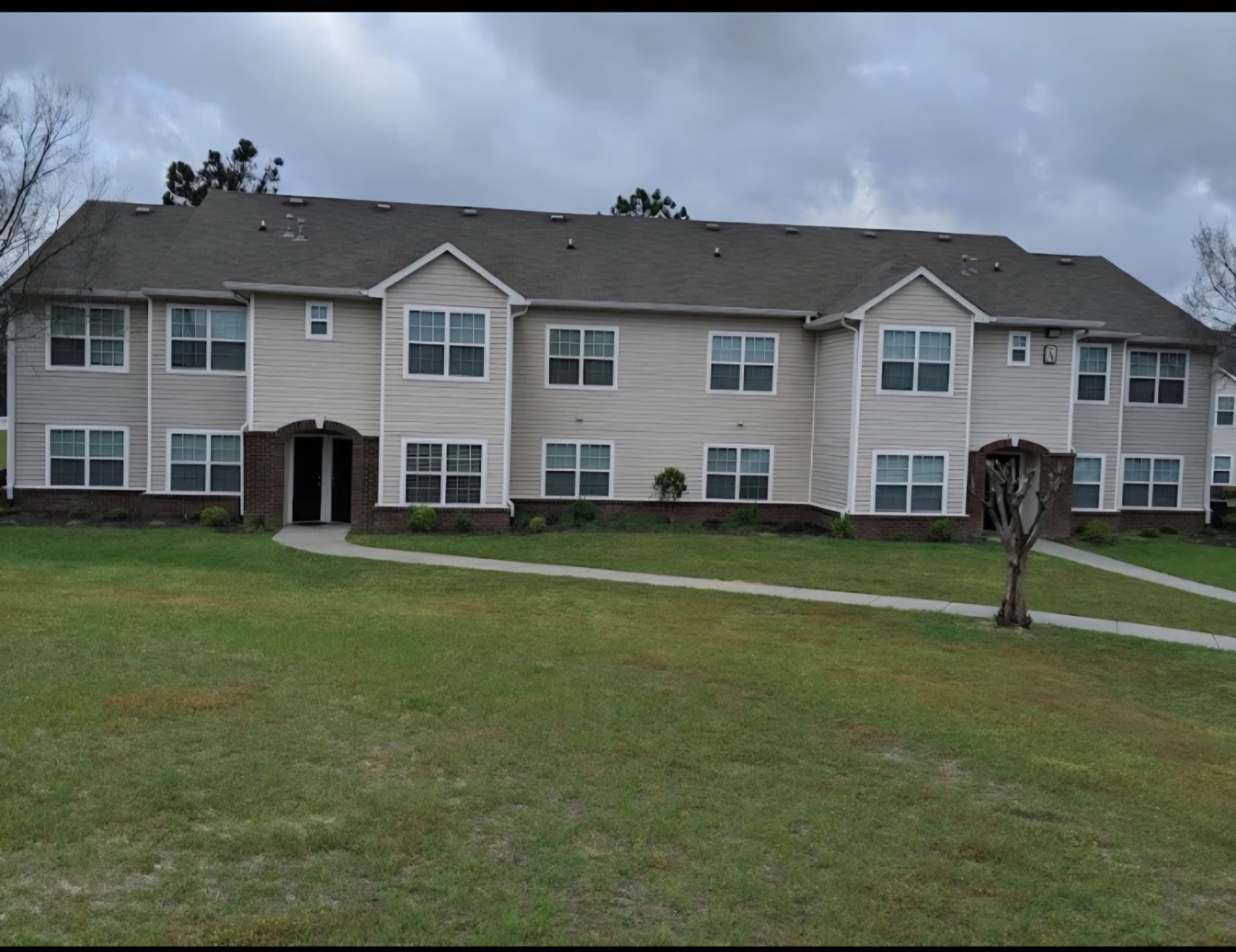 Manicured apartment complex lawn and walkway