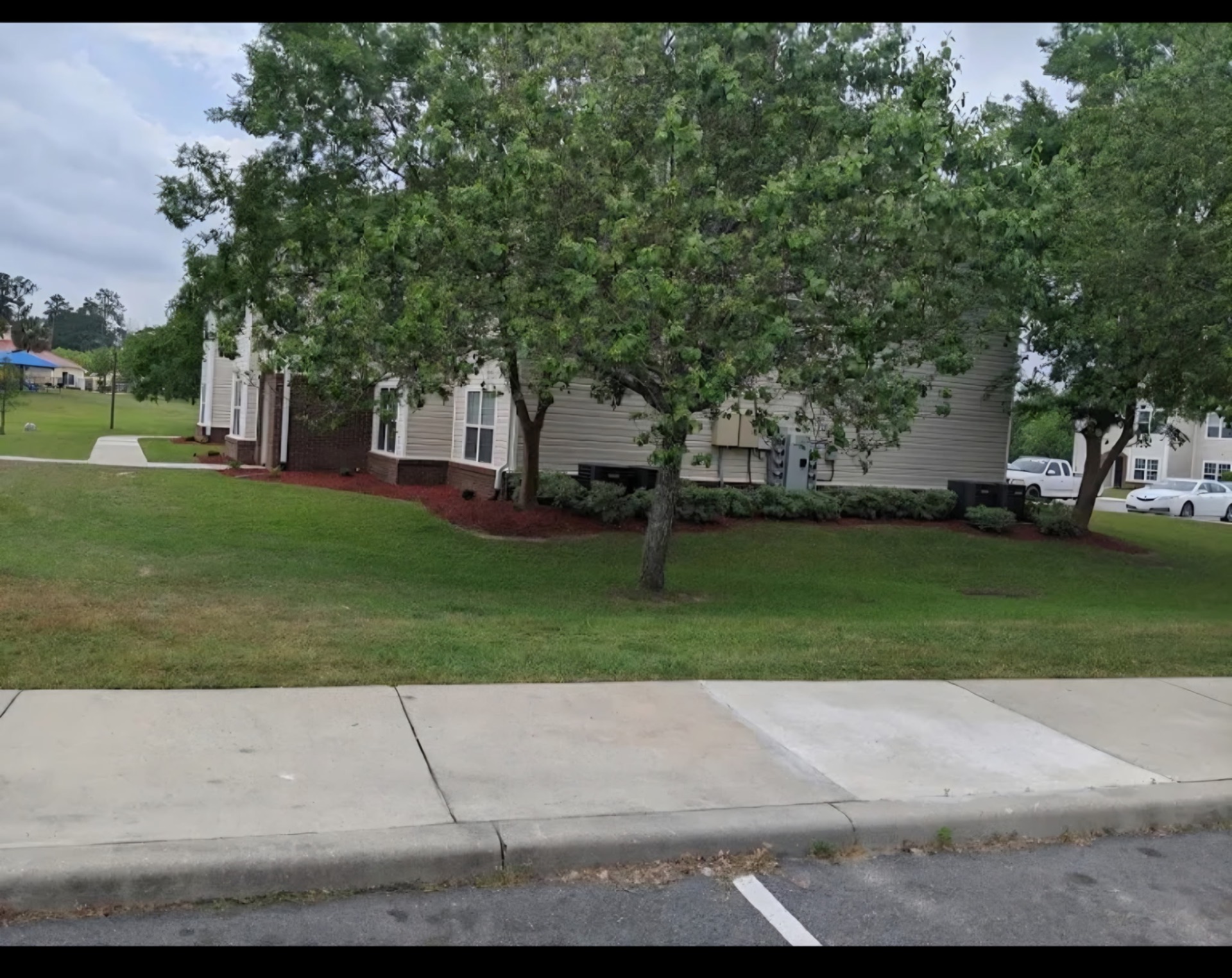 Commercial property landscaping with fresh red mulch beds